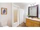 Bathroom with vanity, shower, and wood-look floors that evoke a sense of luxury at 1287 N Alma School Rd # 171, Chandler, AZ 85224