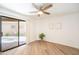 Sunlit bedroom featuring a ceiling fan, sliding glass door, and neutral decor at 1287 N Alma School Rd # 171, Chandler, AZ 85224
