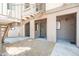 Exterior of a light beige apartment building with gravel landscaping and metal stairs at 1287 N Alma School Rd # 171, Chandler, AZ 85224