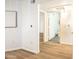 Bright hallway with wood floors leading to a bathroom showcases clean, modern design at 1287 N Alma School Rd # 171, Chandler, AZ 85224