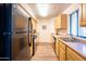 Galley kitchen with a refrigerator and cabinets at 1287 N Alma School Rd # 171, Chandler, AZ 85224
