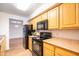 Kitchen featuring black appliances and wood cabinets at 1287 N Alma School Rd # 171, Chandler, AZ 85224