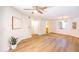 Spacious living room featuring light wood floors, white walls and ceiling fan at 1287 N Alma School Rd # 171, Chandler, AZ 85224