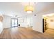 Well-lit living room with wood floors leading to an adjacent kitchen area at 1287 N Alma School Rd # 171, Chandler, AZ 85224