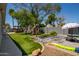 Lush backyard featuring artificial turf, a playground, and a paved patio perfect for Gathering fun at 1311 W Ellis St, Mesa, AZ 85201