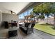Inviting backyard with a covered patio, outdoor kitchen, artificial turf, and comfortable seating area at 1311 W Ellis St, Mesa, AZ 85201