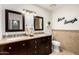 Well-appointed bathroom featuring double sinks, granite counters, decorative tile accents, and updated fixtures at 1311 W Ellis St, Mesa, AZ 85201