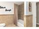 Bathroom showcasing a tiled tub, shower combination, and updated fixtures at 1311 W Ellis St, Mesa, AZ 85201