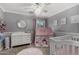 Bedroom with elegant decor, including a crib, chandelier, and decorative mirror at 1311 W Ellis St, Mesa, AZ 85201