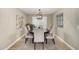 Dining room boasts a wooden table, upholstered chairs, an elegant chandelier, and plantation shutters at 1311 W Ellis St, Mesa, AZ 85201