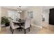 This dining room has a wooden table, upholstered chairs, a modern chandelier, and neutral decor at 1311 W Ellis St, Mesa, AZ 85201