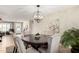The formal dining room is bright and neutral, showcasing a wooden table and globe chandelier at 1311 W Ellis St, Mesa, AZ 85201