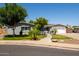 Cozy single-story home with shutters, mature landscaping, and a paved front patio at 1311 W Ellis St, Mesa, AZ 85201