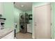 Functional laundry room with stacked washer/dryer, utility sink, and ample storage space at 1311 W Ellis St, Mesa, AZ 85201