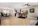 Open-concept living area features tile flooring, a piano, and seamless flow to the dining area at 1311 W Ellis St, Mesa, AZ 85201