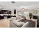 Open-concept living room connected to the kitchen features a fireplace and comfortable sectional sofa at 1311 W Ellis St, Mesa, AZ 85201