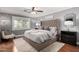 Comfortable main bedroom with a plush king-size bed, soft rug, and ceiling fan at 1311 W Ellis St, Mesa, AZ 85201