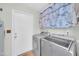 Laundry room featuring new appliances, tile flooring, and white door at 13219 N 26Th Ave, Phoenix, AZ 85029