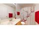 Bright bathroom featuring a single vanity, a decorative shower curtain and red accent towels at 16537 N Oachs Dr, Surprise, AZ 85374