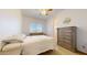 Comfortable bedroom with a ceiling fan, large window, and neutral tones, creating a calming and inviting atmosphere at 16537 N Oachs Dr, Surprise, AZ 85374