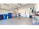 Spacious garage with insulated door, overhead lighting, and ample storage and workspace at 16537 N Oachs Dr, Surprise, AZ 85374