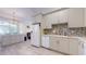Well-lit kitchen featuring modern appliances, updated cabinetry, and light wood flooring, a modern design aesthetic at 16537 N Oachs Dr, Surprise, AZ 85374