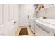 Bright laundry room features modern washer, dryer, shelving, storage and convenient access to utilities at 16537 N Oachs Dr, Surprise, AZ 85374