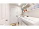 Clean laundry room with modern washer and dryer, shelving, and door to the exterior at 16537 N Oachs Dr, Surprise, AZ 85374
