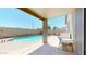 A covered patio offers a cool view of the sparkling pool with a lounge area for outdoor enjoyment at 16537 N Oachs Dr, Surprise, AZ 85374