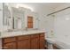 Bathroom with stone countertops, wood cabinets, and bathtub-shower combo at 1825 W Ray Rd # 1070, Chandler, AZ 85224