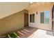 Apartment exterior with brown front door, beige walls, and small decorative rock garden at 1825 W Ray Rd # 1070, Chandler, AZ 85224