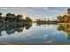 Picturesque lake view reflecting the sky, trees, and waterfront buildings at 1825 W Ray Rd # 1070, Chandler, AZ 85224