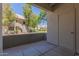 View from a concrete patio of a residential building surrounded by lush trees and well-maintained landscaping at 1825 W Ray Rd # 1070, Chandler, AZ 85224