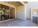 Exterior patio with sliding glass door, tan stucco wall, and concrete tile at 1825 W Ray Rd # 1070, Chandler, AZ 85224