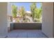 View from a concrete patio of a residential building surrounded by lush trees and well-maintained landscaping at 1825 W Ray Rd # 1070, Chandler, AZ 85224