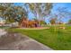 Community playground featuring a colorful play structure, lush green grass, and mature trees at 1825 W Ray Rd # 1070, Chandler, AZ 85224