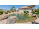 Picturesque pond featuring a gentle fountain and surrounded by lush landscaping and mature trees at 1825 W Ray Rd # 1070, Chandler, AZ 85224