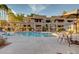 Community pool area with sun loungers and pergola in an apartment complex at 1825 W Ray Rd # 1070, Chandler, AZ 85224