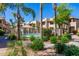 Community pool area surrounded by palm trees and lush landscaping at 1825 W Ray Rd # 1070, Chandler, AZ 85224