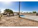 A backyard featuring a pool, home with solar panels, and desert landscaping at 1906 N Evergreen St, Chandler, AZ 85225