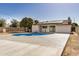 Backyard with a beautiful pool, patio, and white home with solar panels at 1906 N Evergreen St, Chandler, AZ 85225