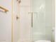 A luxurious bathroom showcasing a sleek glass shower with gold fixtures and a modern design at 1906 N Evergreen St, Chandler, AZ 85225