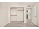 Bedroom with carpet, open closet, and doorway to adjoining room at 1906 N Evergreen St, Chandler, AZ 85225