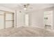 Bedroom featuring a ceiling fan, carpet, open closet, and doorway to an ensuite bathroom at 1906 N Evergreen St, Chandler, AZ 85225