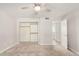 Bedroom featuring a ceiling fan, carpet, open closet, and doorway to adjoining room at 1906 N Evergreen St, Chandler, AZ 85225