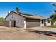 Side view of a single-story home featuring a two-car garage and solar panels at 1906 N Evergreen St, Chandler, AZ 85225