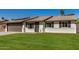 Charming single-story home with a well-manicured lawn and a two-car garage, complemented by solar panels at 1906 N Evergreen St, Chandler, AZ 85225