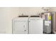 Laundry room area featuring a white washer, dryer, and water heater at 1906 N Evergreen St, Chandler, AZ 85225