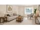 Staged living room with neutral colors, decor, and a view to the outdoors at 1906 N Evergreen St, Chandler, AZ 85225