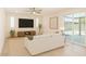 Bright living room with modern decor, ceiling fan, and sliding doors to outdoor space at 1906 N Evergreen St, Chandler, AZ 85225